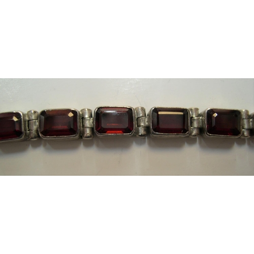 115 - Silver bracelet with red stone panels, 20cms long