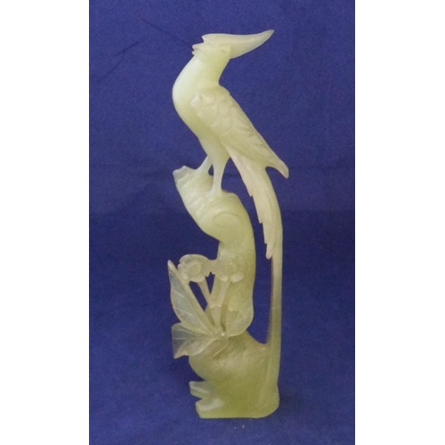 167 - Finely carved jade statue of a bird amongst foliage

26cm high