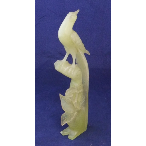 167 - Finely carved jade statue of a bird amongst foliage

26cm high