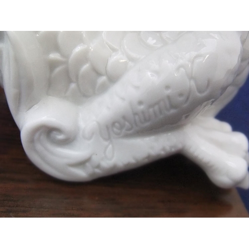 168 - Finely detailed, white fired ceramic dragon (unmarked) on chinese wood plinth,

21 cm long