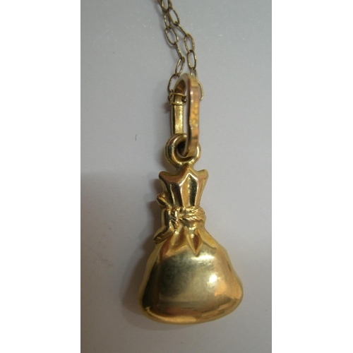 96 - 9ct yellow gold chain & pendant denoting a bag of money

Approx 1.1 grams gross,          16