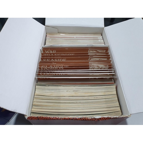 262 - Collection of Nostalgia postcards (box full) together with a large tin of used Belgium 3 franc stamp... 