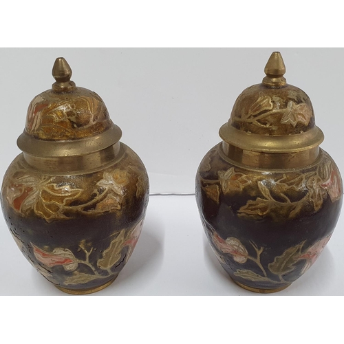 141 - Pair of small enamel covered lidded vases decorated with leaf decoration,

Both 11 cm tall