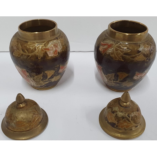 141 - Pair of small enamel covered lidded vases decorated with leaf decoration,

Both 11 cm tall