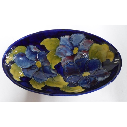 161 - Moorcroft Clematis on dark blue back-ground, shallow oval dish, 23 cm, signed to underside

14 x 23 ... 