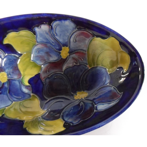 161 - Moorcroft Clematis on dark blue back-ground, shallow oval dish, 23 cm, signed to underside

14 x 23 ... 