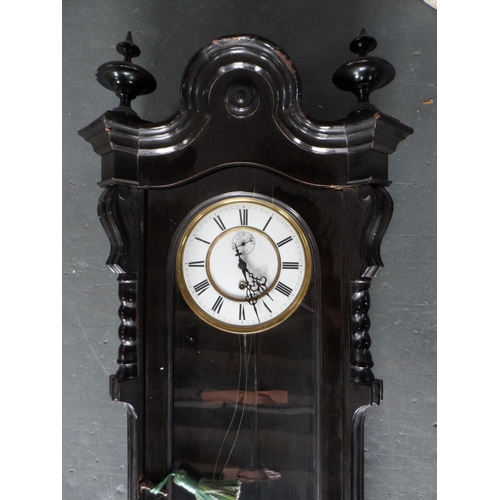 209 - Large antique ebonised ornate wooden wall clock, complete with key, unmarked,

115 cm long,       R1... 