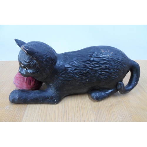 165 - Bretby pottery model of a cat with glass eyes holding a reel of wool in its forelegs, 24cm long,

Im... 