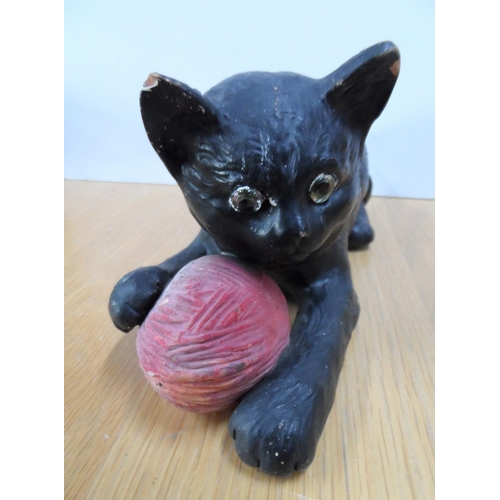 165 - Bretby pottery model of a cat with glass eyes holding a reel of wool in its forelegs, 24cm long,

Im... 