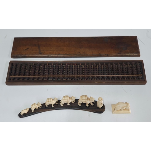 145 - Old boxed Chinese abacus together with antique small carved graduating ivory camels & another small ... 