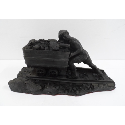 14 - Made from British coal is this figure of a Man pushing a small coal cart,