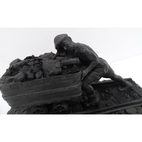 14 - Made from British coal is this figure of a Man pushing a small coal cart,