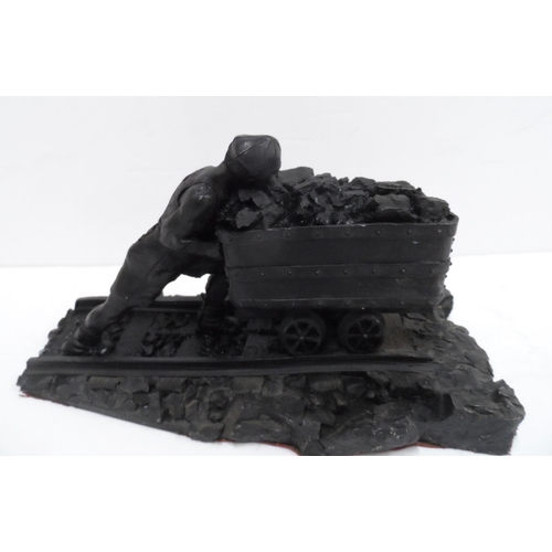 14 - Made from British coal is this figure of a Man pushing a small coal cart,