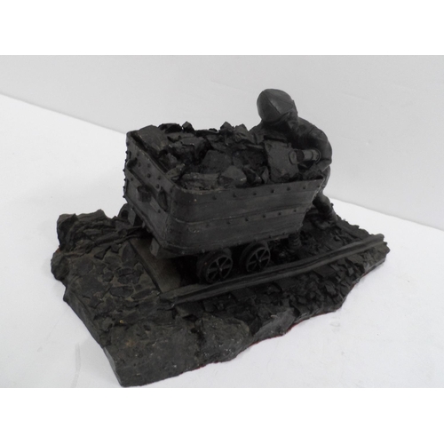 14 - Made from British coal is this figure of a Man pushing a small coal cart,