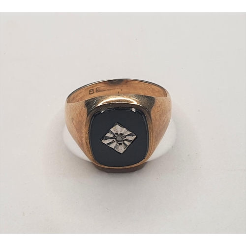 85 - 9ct yellow gold & onyx ring set with a small central diamond,

Size O       4.3 grams gross