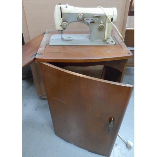 434 - Vintage Necchi sewing machine in foldaway wooden cabinet, compete with original papers etc,

The cab... 