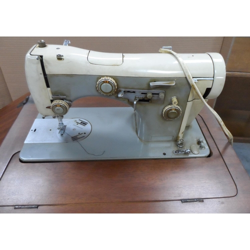 434 - Vintage Necchi sewing machine in foldaway wooden cabinet, compete with original papers etc,

The cab... 