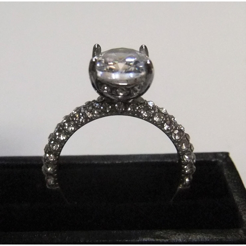 440 - 14ct white gold with large CZ solitaire stone with addional CZ stones addorning the upper part of ea... 