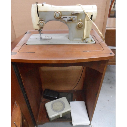 390 - Vintage Necchi sewing machine in foldaway wooden cabinet, compete with original papers etc,

The cab... 