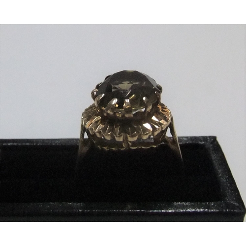 22 - 9ct yellow gold ring with large smokey quartz

Approx 3.8 grams gross,          size N