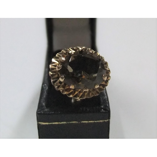 22 - 9ct yellow gold ring with large smokey quartz

Approx 3.8 grams gross,          size N