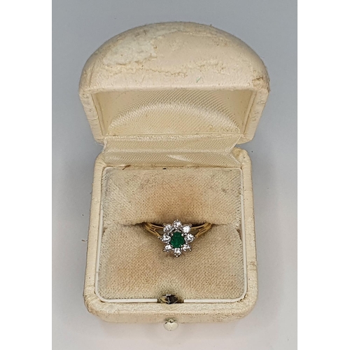 39 - 18ct yellow gold ring set with an oval cut Emerald surrounded by 8 round cut diamonds.

Gross weight... 