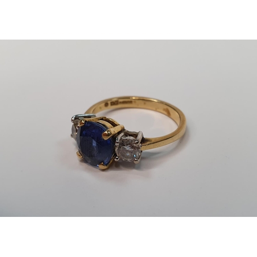 49 - 18ct yellow gold ring set with a central Sapphire (approx 2.2cts) flanked to either side by a round ... 