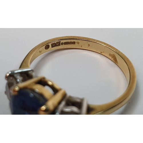 49 - 18ct yellow gold ring set with a central Sapphire (approx 2.2cts) flanked to either side by a round ... 
