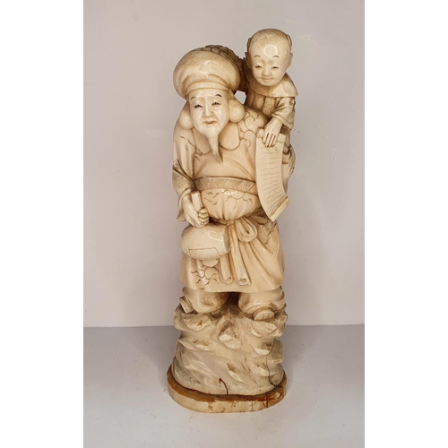 108 - Meiji period, Japanese carving of Deity with a mallet carrying a child 21cm tall