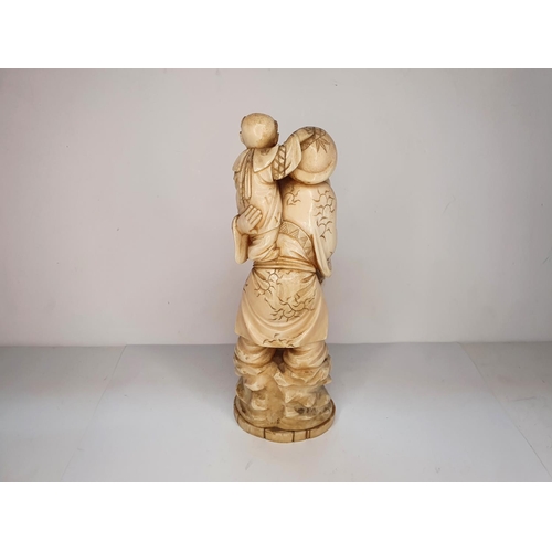 108 - Meiji period, Japanese carving of Deity with a mallet carrying a child 21cm tall