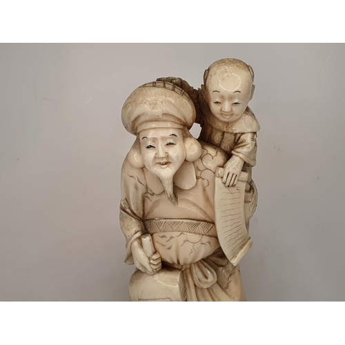 108 - Meiji period, Japanese carving of Deity with a mallet carrying a child 21cm tall