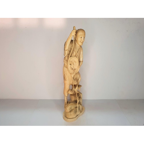 111 - Meiji period, Japanese carving of a fisherman.  27 cm tall