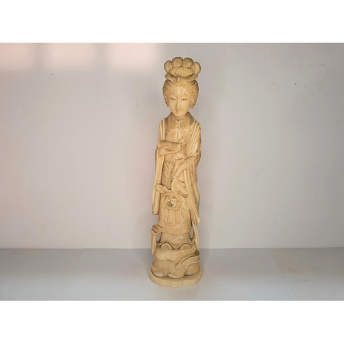 115 - Meiji period, Japanese carving of Geisha carrying a flower.  21 cm tall