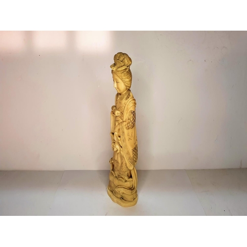 115 - Meiji period, Japanese carving of Geisha carrying a flower.  21 cm tall