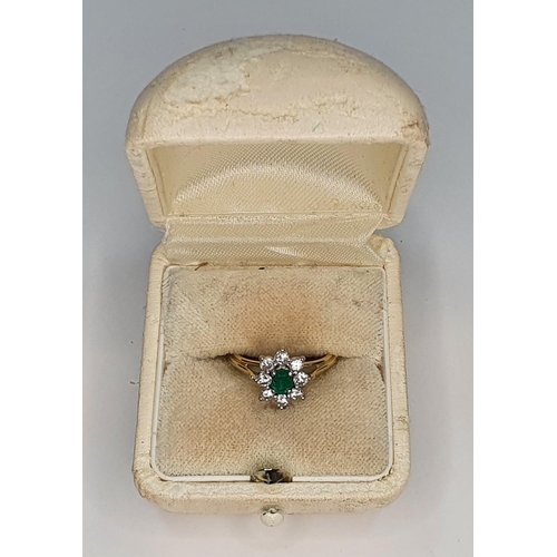 38 - 18ct yellow gold ring set with an oval cut Emerald surrounded by 8 round cut diamonds.

Gross weight... 