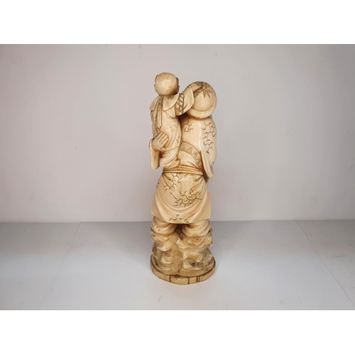 109 - Meiji period, Japanese carving of Deity with a mallet carrying a child 21cm tall