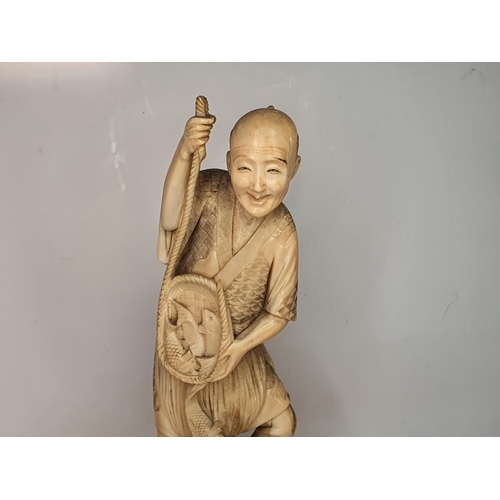 110 - Meiji period, Japanese carving of a fisherman.  27 cm tall