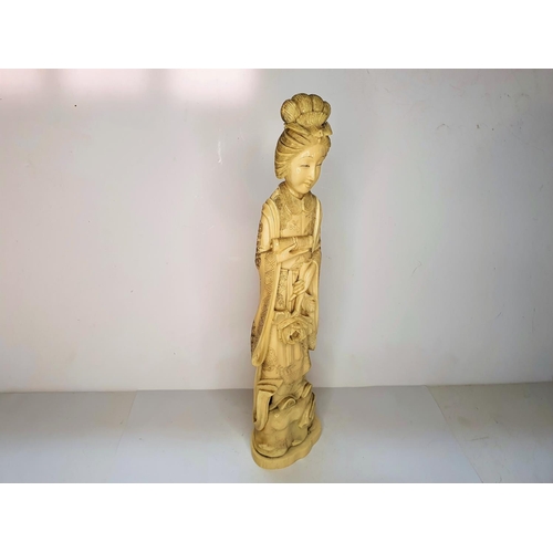 111 - Meiji period, Japanese carving of Geisha carrying a flower.  21 cm tall