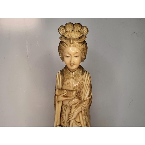 111 - Meiji period, Japanese carving of Geisha carrying a flower.  21 cm tall