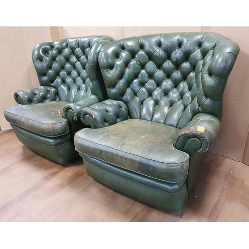 540 - Two vintage, over-sized green leather Chesterfield wing back armchairs (a/f)