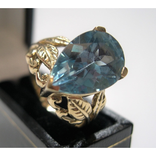 37 - 9ct yellow gold ring with large pear cut blue topaz,

stone measures approx 15mm x 10mm

Approx 5.6 ... 