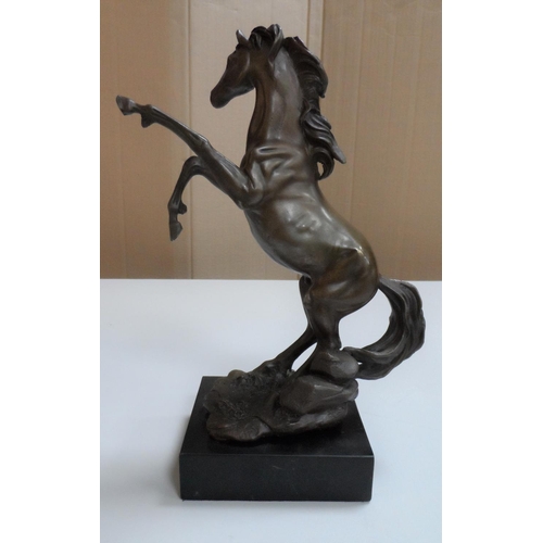 97 - Unsigned, well cast, 20thC bronze depicting a rearing horse on plinth,

27 cm tall