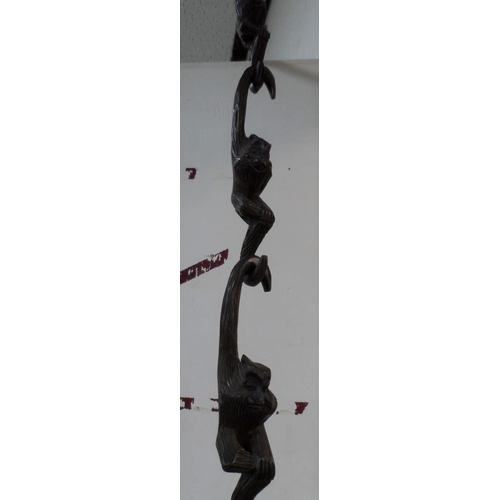 124 - Hanging carved monkies, individually cut but which link and hang together