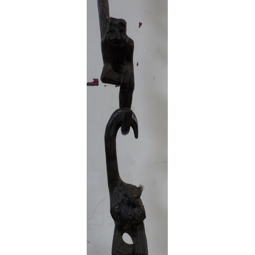 124 - Hanging carved monkies, individually cut but which link and hang together