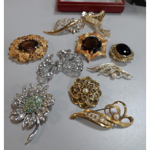 46 - Ten good quality vintage costume brooches in an Omega watch box  together with other costume jewelle... 