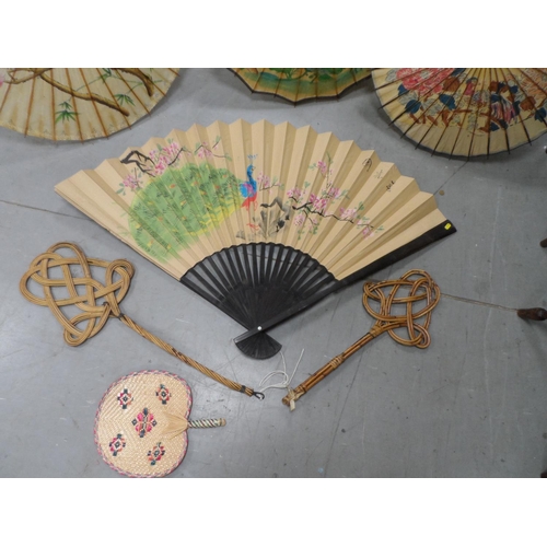 450 - Three painted Japanese parasols together with a handpainted over-sized Japanese fan, another fan and... 