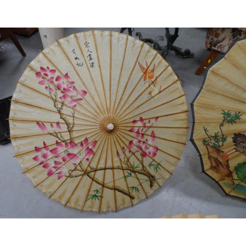 450 - Three painted Japanese parasols together with a handpainted over-sized Japanese fan, another fan and... 