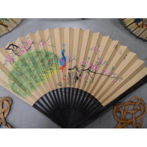 450 - Three painted Japanese parasols together with a handpainted over-sized Japanese fan, another fan and... 