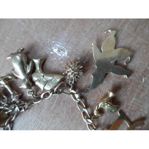 46 - Ladies 9ct yellow gold charm bracelet with approx 22 gold charms, some stamped, some unmarked,

23.7... 
