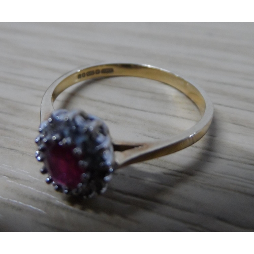 42 - 9ct yellow gold ladies ruby ring surrounded by diamonds,

1.8 grams gross            N1/2
